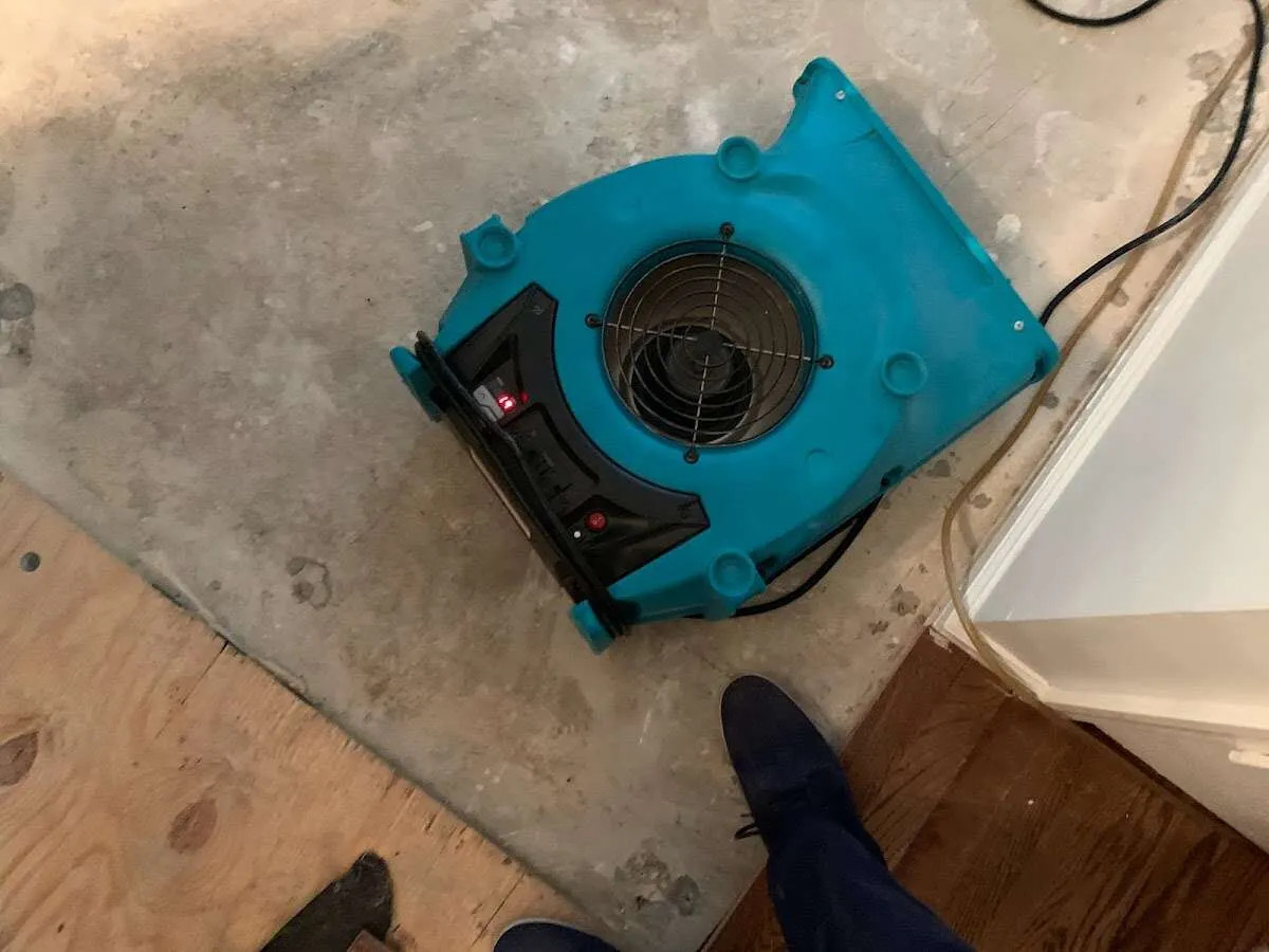 Air mover drying subfloor during Leak Detection & Repair in Germantown